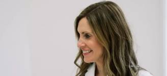 Female medical provider smiling in a clinical setting