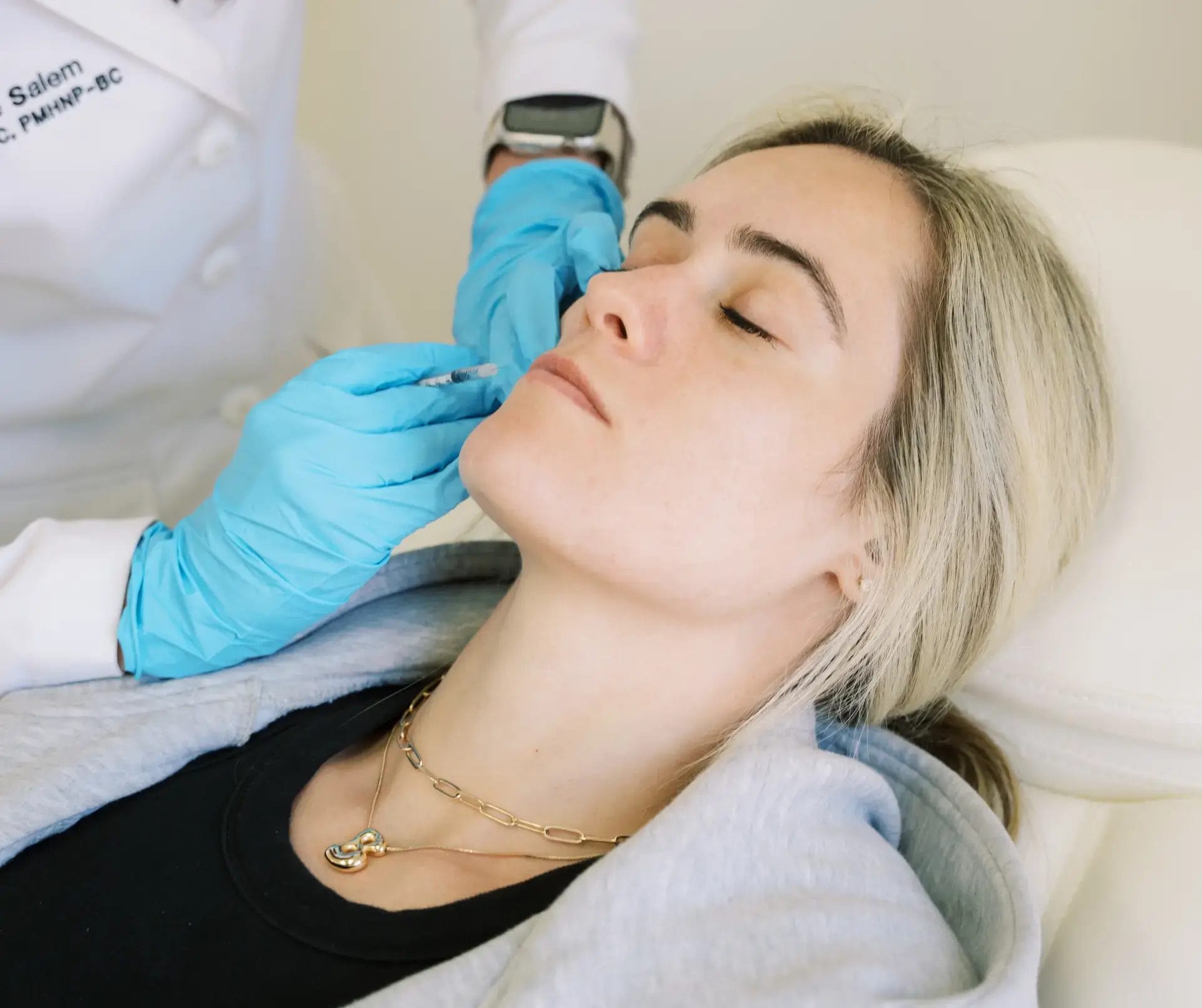 Medical professional administering cosmetic injectables for facial rejuvenation.